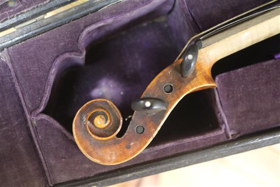A cased violin and bows